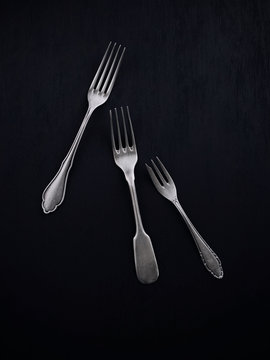 Three forks on black background