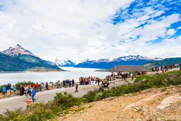 PATAGONIA, ARGENTINA - JANUARY 7, 2018: A group of people on the background of the Perito Moreno Glacier. With selective focus.