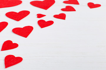 Red hearts of different sizes on a white background. Harvesting cards for Valentine's Day. Place for text, copy space.