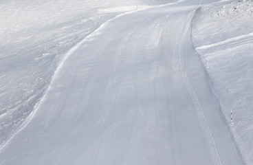 Prepared snowy ski slope after snow grooming machine