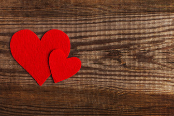 Red hearts on a wooden table. Blank or greeting card background for Valentine's Day. Place for text, copy space.