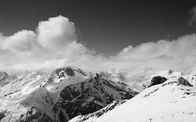 Black and white panorama of ski resort and snowy mountains