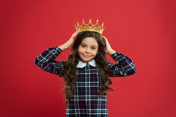 Monarch attribute. Kid wear golden crown symbol of princess. Every girl dreaming to become princess. Lady little princess. Girl wear crown red background. Monarch family concept. Princess manners