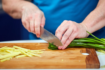 Man chopping spring onions