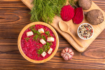 Bright tasty pureed beetroot soup with ingredients. Healthy food