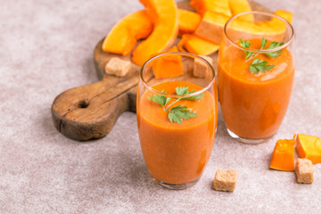 Fresh pumpkin smoothie in tumbler with parsley