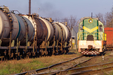 Fototapeta na wymiar Transportation of oil tanks at sunset, transportation by rail
