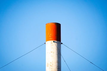 Pipe against blue sky, industry, environmental pollution