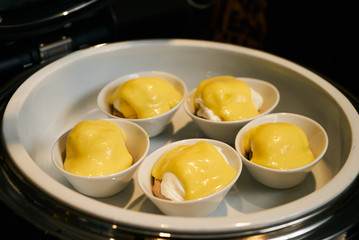 Eggs Benedict- English breakfast, close-up. Hotel restaurant buf