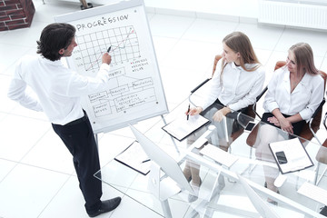 Obraz na płótnie Canvas businessman presenting his new marketing plan to his coworkers.