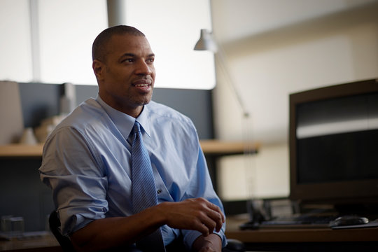 Mid-adult businessman sitting in an office.