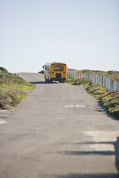 A yellow school bus on a country road