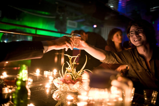 Young adult women having cocktails in a bar.