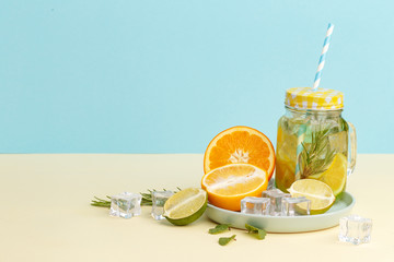 Citrus lemonade water with lemon sliced , healthy and detox water drink in summer on light-blue background