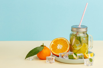 Citrus lemonade water with lemon sliced , healthy and detox water drink in summer on light-blue background