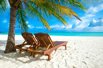 tropical Maldives island with white sandy beach and sea