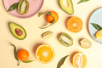 Citrus food on ligth-yellow background - assorted citrus fruits with mint leaves. Top view.