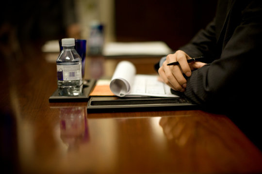 Notes being taken by people in a boardroom.