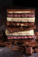 Chocolate bars on table with chocolate tower.