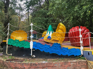 Multicolored carousel in an empty amusement park in late summer