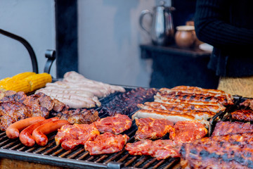 Traditional european grilled meat with smoke on Christmas fair