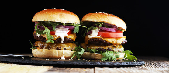 Tasty fresh meat burgers with salad and cheese. Homemade angus burger.