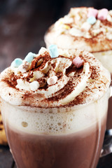 Hot chocolate cocoa with whipped cream on table.