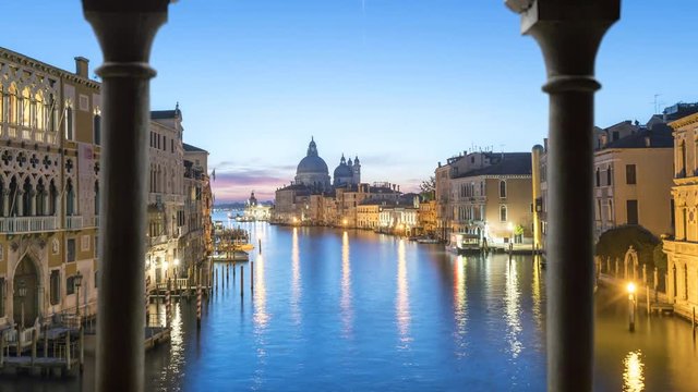 Venice italy skyline aerial view from day to night seen from old balcony window.