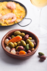 Traditional Spanish olives on the plate. Mixed with carrot and onion