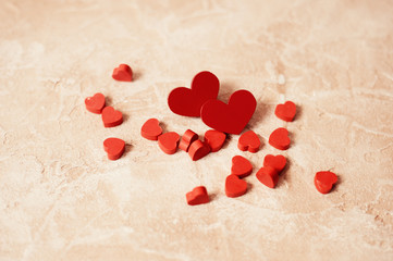 Valentines day concept. Couple of red wooden hearts on wooden background.