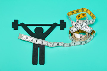 weightlifting pictogram wiht pills and tape measure