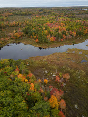 Aerial view of a beautiful lake during a cloudy autumn day. Taken in Lily Lake, near Annapolis, Nova Scotia, Canada.