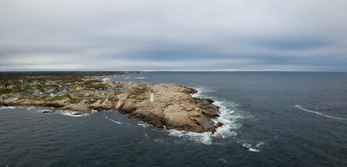 Aerial panoramic view of a small town near a rocky coast on the Atlantic Ocean. Taken in Peggy...