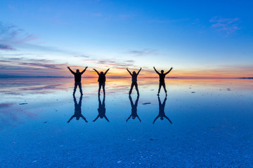People reflections at Uyuni saltflats. One of the most amazing things that a photographer can see. The sunrise over an infinite horizon with the Uyuni salt flats making a wonderful mirror to infinity