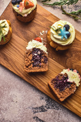Obraz na płótnie Canvas Handmade capcake with blueberries on wood background top view.