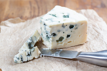 Roquefort soft French cheese made from sheep milk on  south of France, one of the world's best known blue cheeses with blue mold