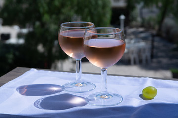 Rose wine of Provence, France, served cold on outdoor terrace in two wine glasses