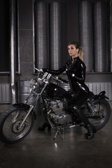 Plakat Sexy biker girl in a latex on a motorcycle