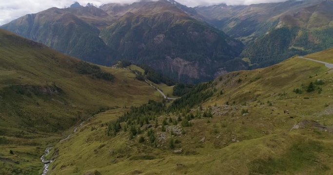 Austrian mountains, C4k aerial, tilt up, drone shot, of alpine nature, in a valley, on Grossglockner mountain pass, on a cloudy, summer day, in the alps of Austria
