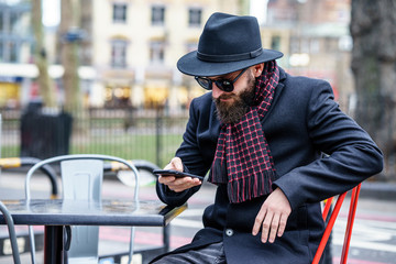 good looking beard man using mobile 