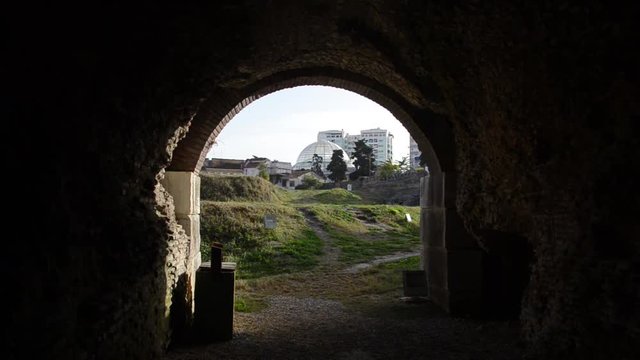 View on modern city from ancient tunnel. The Roman Amphitheatre And Ruins. Ancient roman city. Roman Empire. Amphitheatre of Durr&euml;s, Albania, Europe. Amphitheatrum Dyrrhachium