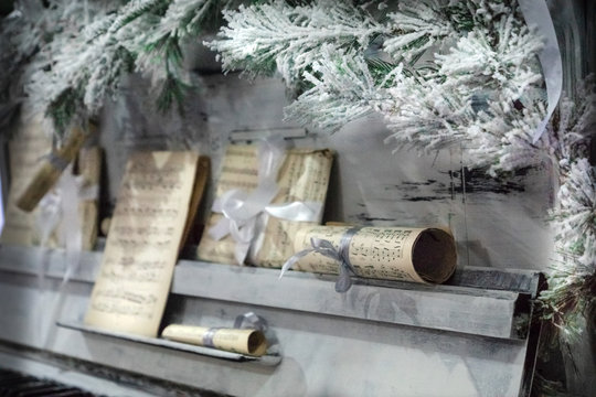 Piano Under The Christmas Tree Branches And Notes