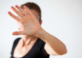 woman holding her palm against camera - stop violence against women