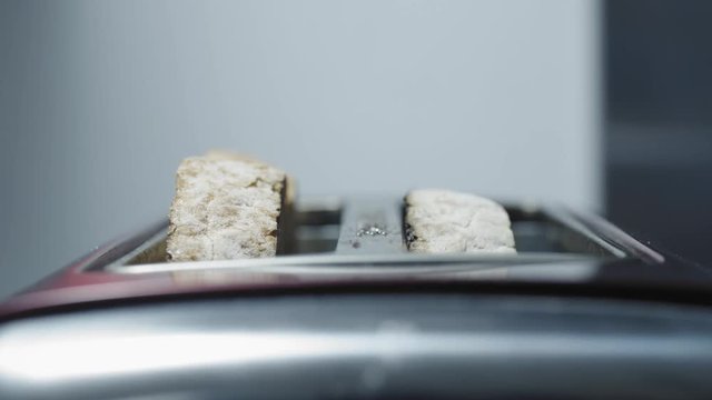 Prepareing toast in a home kitchen. Good quality bread and good quality butter. Cinematic lighting with suttle grading.