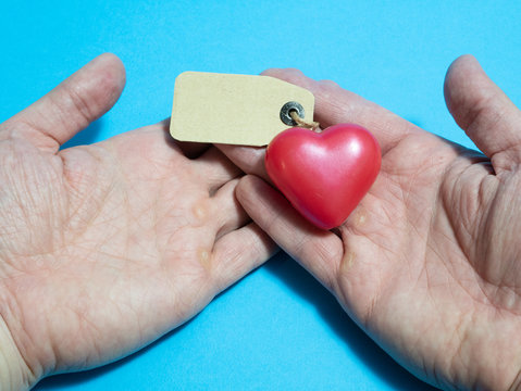 heart in human hands with empty label. donor organ donation list