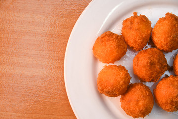Cheese balls, Breaded mozzarella cheese balls with tomato in white dish on wood blackground