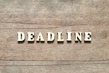 Letter block in word deadline on wood background