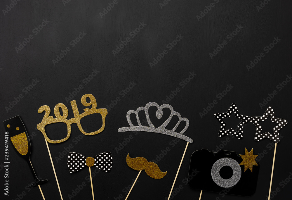 Wall mural Table top view of Merry Christmas decorations & Happy new year 2019 ornaments concept.Flat lay essential difference objects to party season the photo booth prob on modern wooden black background.