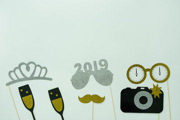 Table top view of wedding celebrate & Happy new year 2019 ornaments concept.Flat lay essential difference objects to party season the photo booth prob paper on modern rustic wooden white background.