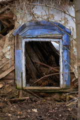 Abandoned dilapidated house in the winter forest. Old wooden windows with preserved decorative elements. Authentic architecture.  Ukraine Kiev region.